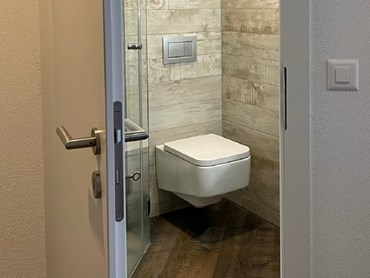A door that opens outwards saves space in the bathroom