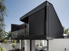 Sleek, contemporary addition to an old weatherboard home