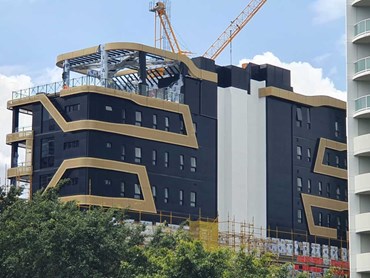 Monterey Apartments featuring black and gold Aodeli SAP cladding