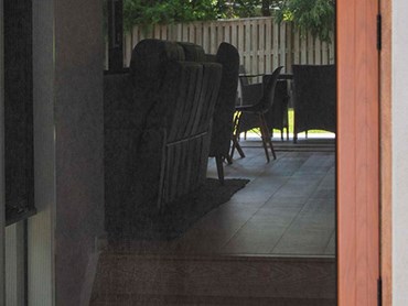 A security screen door with a Woodgrain finish frame