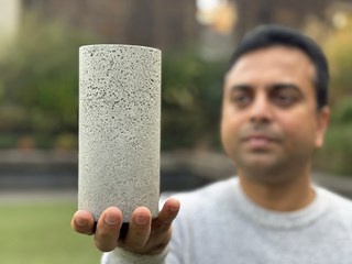 Dr Chamila Gunasekara holds a sample of the low-carbon concrete
