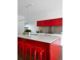 Red lacquered Artek K65 stools from Anibou spice up kitchen for Melbourne home