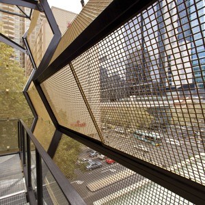 Woven mesh panels create lightweight facade
