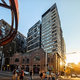 Glass and metal surround Gehry’s brick building in Sydney 