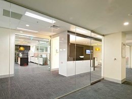 Artesian frameless glass sliding system and aluminium partitioning create breakout room for Melbourne property company
