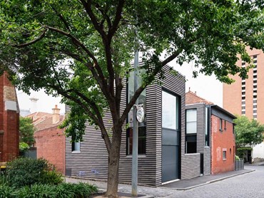The new extension's facades are clad in charcoal-grey Petersen Cover bricks