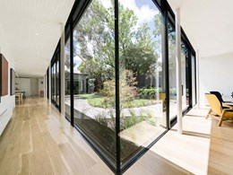 Massive glass panes maximise views into landscaped courtyard at Hawthorn House