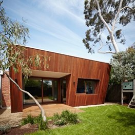 Angled timber-clad facade boosts passive solar design of this house by Mesh Design + Projects