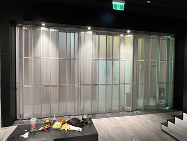 ATDC's commercial sliding doors with perforated mesh infill at Platypus Shoes