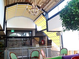 Old retractable roof replaced with retractable curved awnings at Erskineville hotel