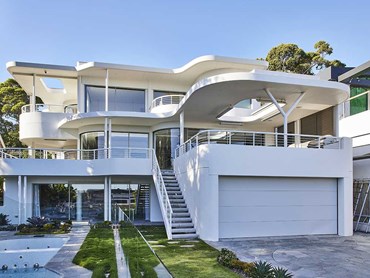 Large panoramic windows celebrate the Mosman home’s harbour and garden views