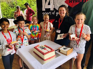 Erin Gilliland with excited cake recipients at Hyne Timber’s 140th birthday celebrations