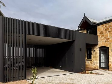 Axon cladding wraps the exterior of the pavilion in almost-black shade Dulux ‘Monument’ 
