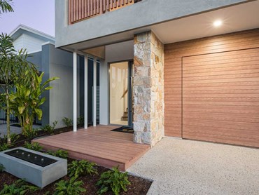 Cladding on the garage door and façade creates a cohesive architectural impact
