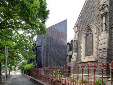 The adaptive reuse of the church and parish hall, and the new black building 