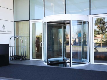 Revolving doors and automatic sliding/swing doors are often complementary