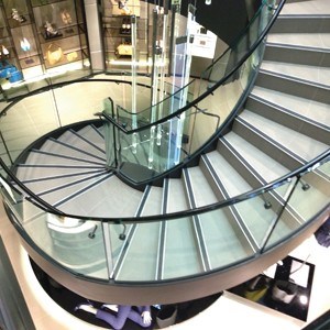 Stunning stair design with curved glass balustrades at Hugo Boss Sydney 