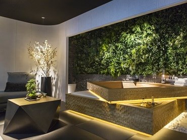 A &lsquo;green wall&rsquo; and the hand carved oak bath provide an &lsquo;outside within&rsquo; feeling. Photo courtesy Mitsui Designtec
