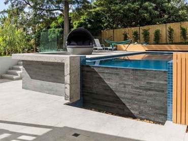 The outdoor space at the Kensington residence featuring the infinity edge pool