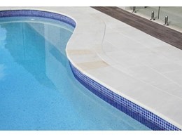 Mint White honed sandstone from Cinajus provides smooth pool surround