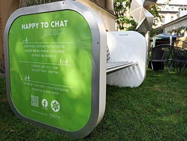 ‘Happy to chat’ bench in Krakow, Poland featuring the sign in Hebrew, Polish and English