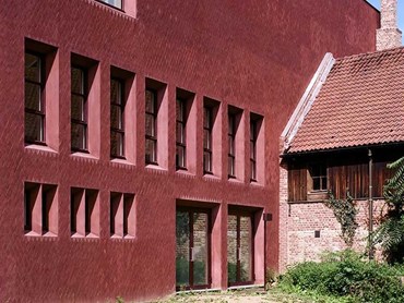 Custom Petersen bricks with a reddish-purple hue are used on the building’s façade 