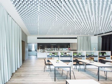 The events/ cafeteria space at EWS Schoenau HQ featuring LIVA open-cell ceiling